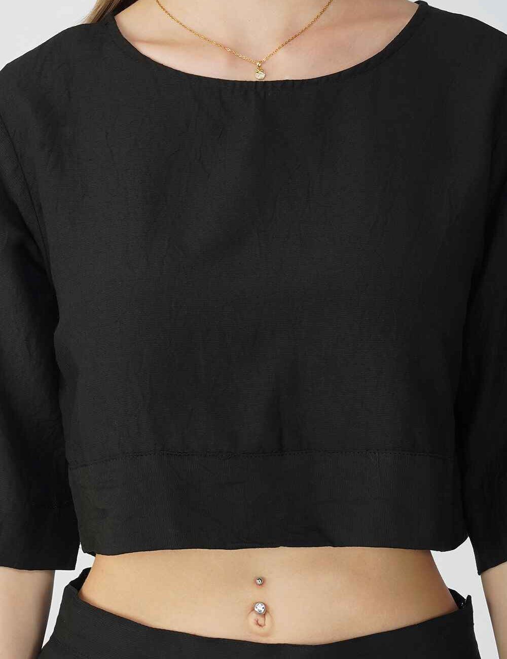 A woman wearing a black cotton linen crop top. She is 5'6" tall, wearing a size M.