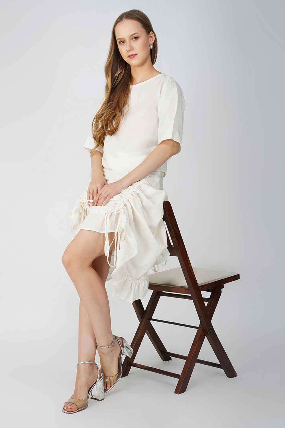Off-white cotton-linen skirt with ruffled hem offering a versatile and elegant style