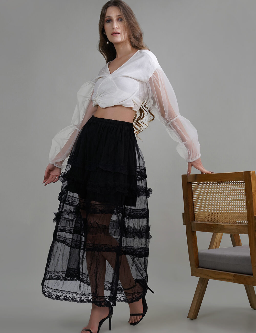 Model wearing Lelamer’s black butterfly net skirt with handmade lace and short inner lining