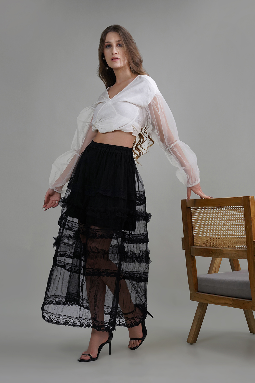 Model wearing Lelamer’s black butterfly net skirt with handmade lace and short inner lining