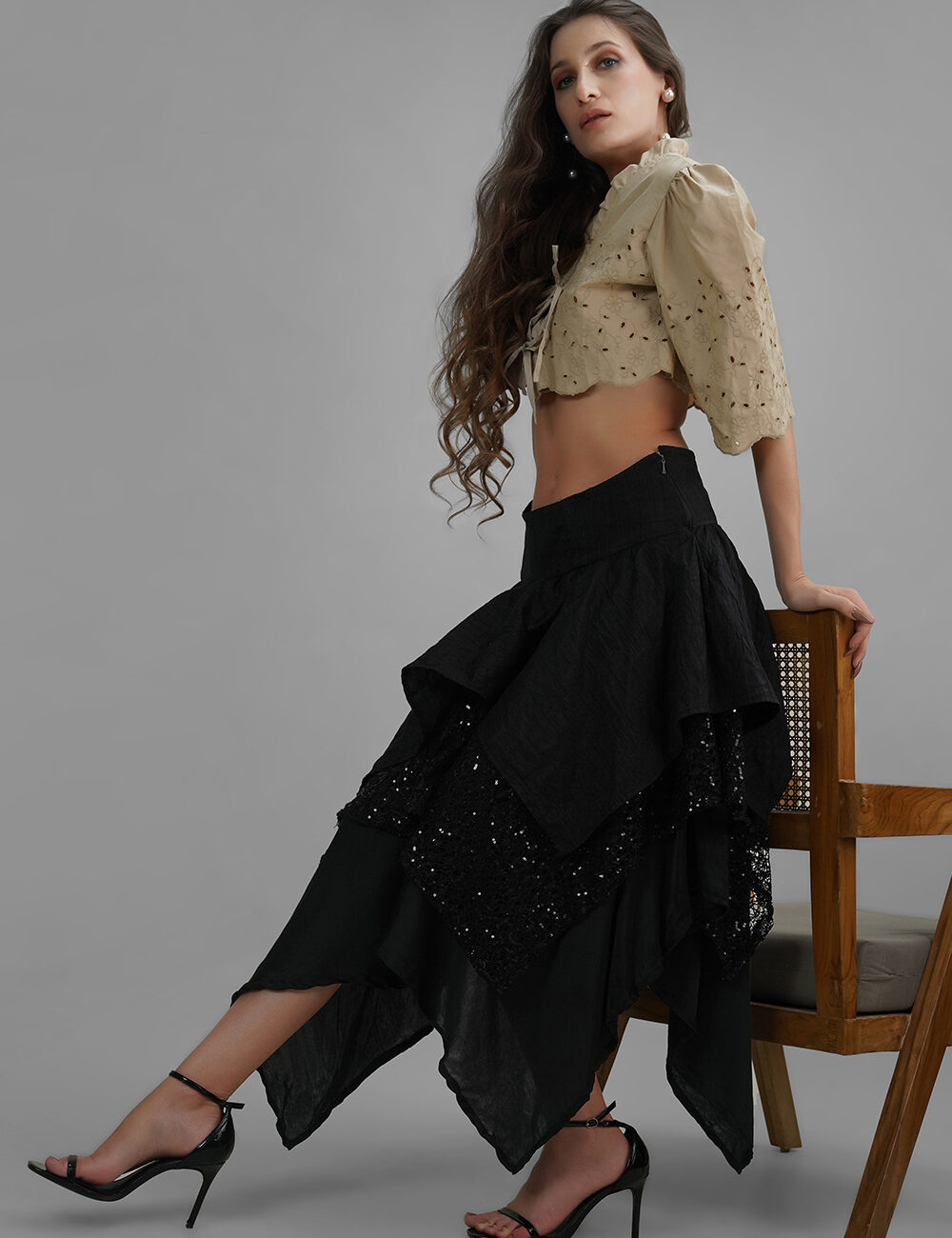Model wearing Lelamer’s Noir Cascade Skirt with layered asymmetrical hem