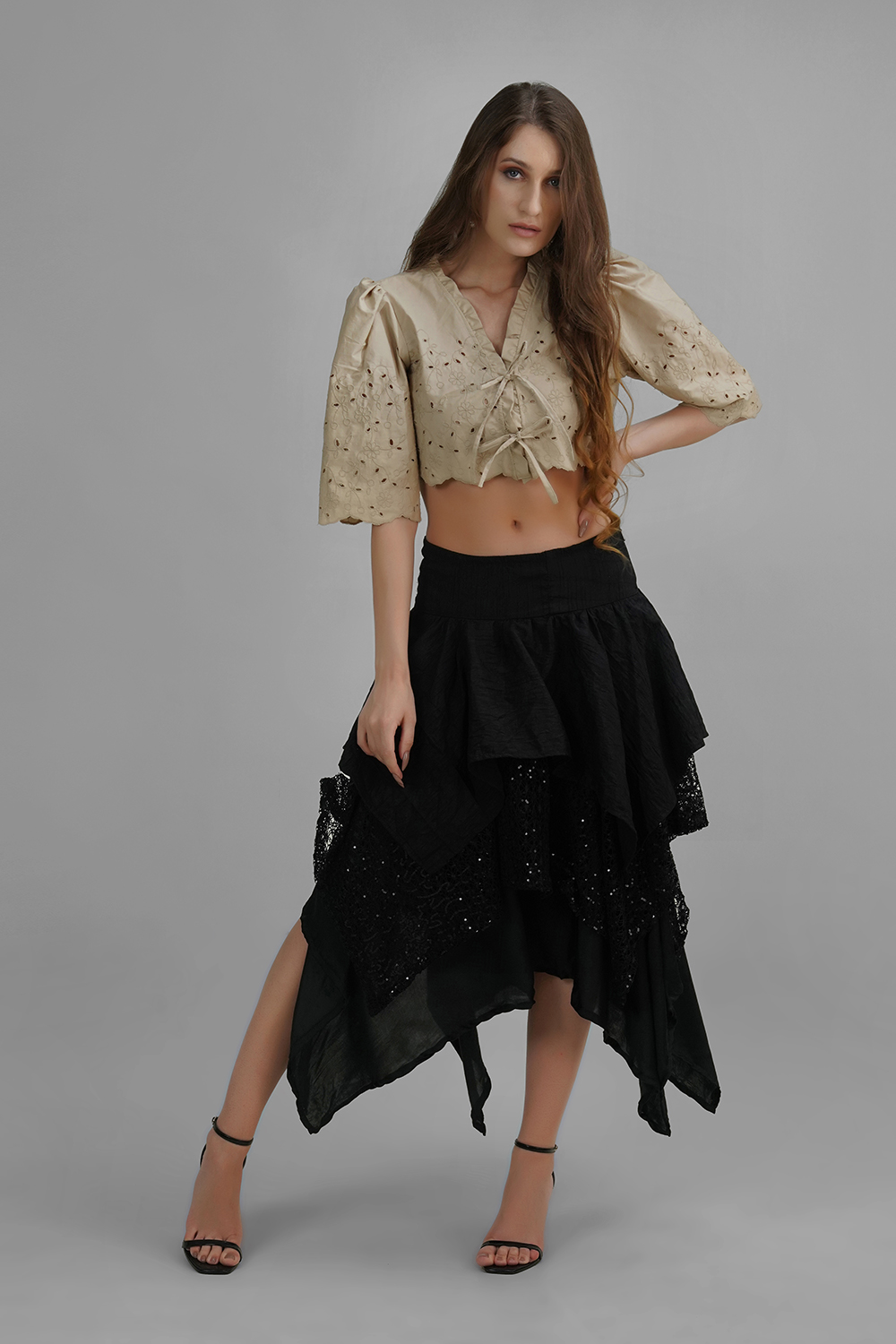 Model wearing Lelamer’s Noir Cascade Skirt with layered asymmetrical hem