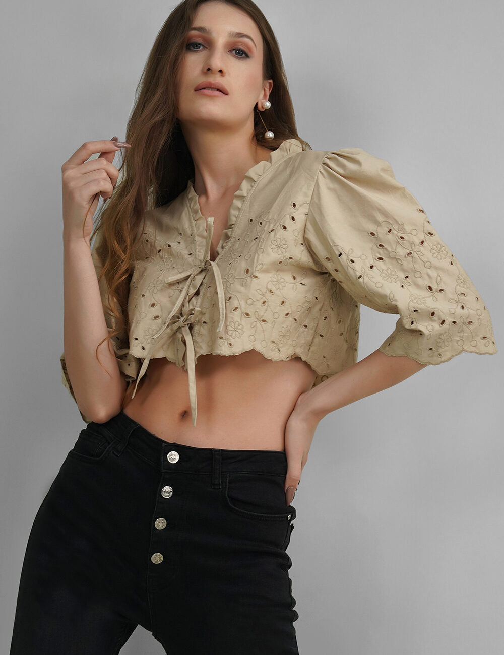 Model wearing beige Hakoba crop top with puff sleeves and tie-up front