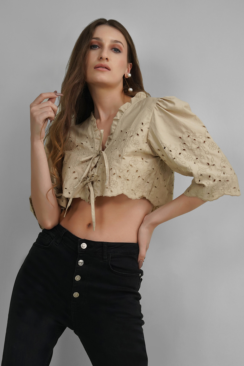 Model wearing beige Hakoba crop top with puff sleeves and tie-up front
