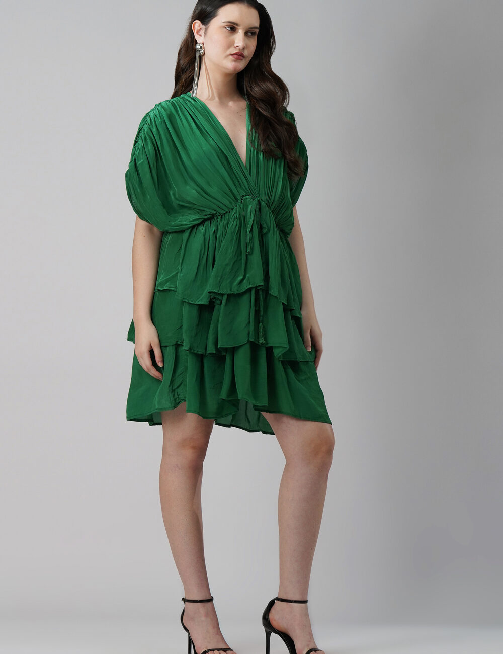 Model wearing emerald green 3-layered V-neck party dress in natural crape
