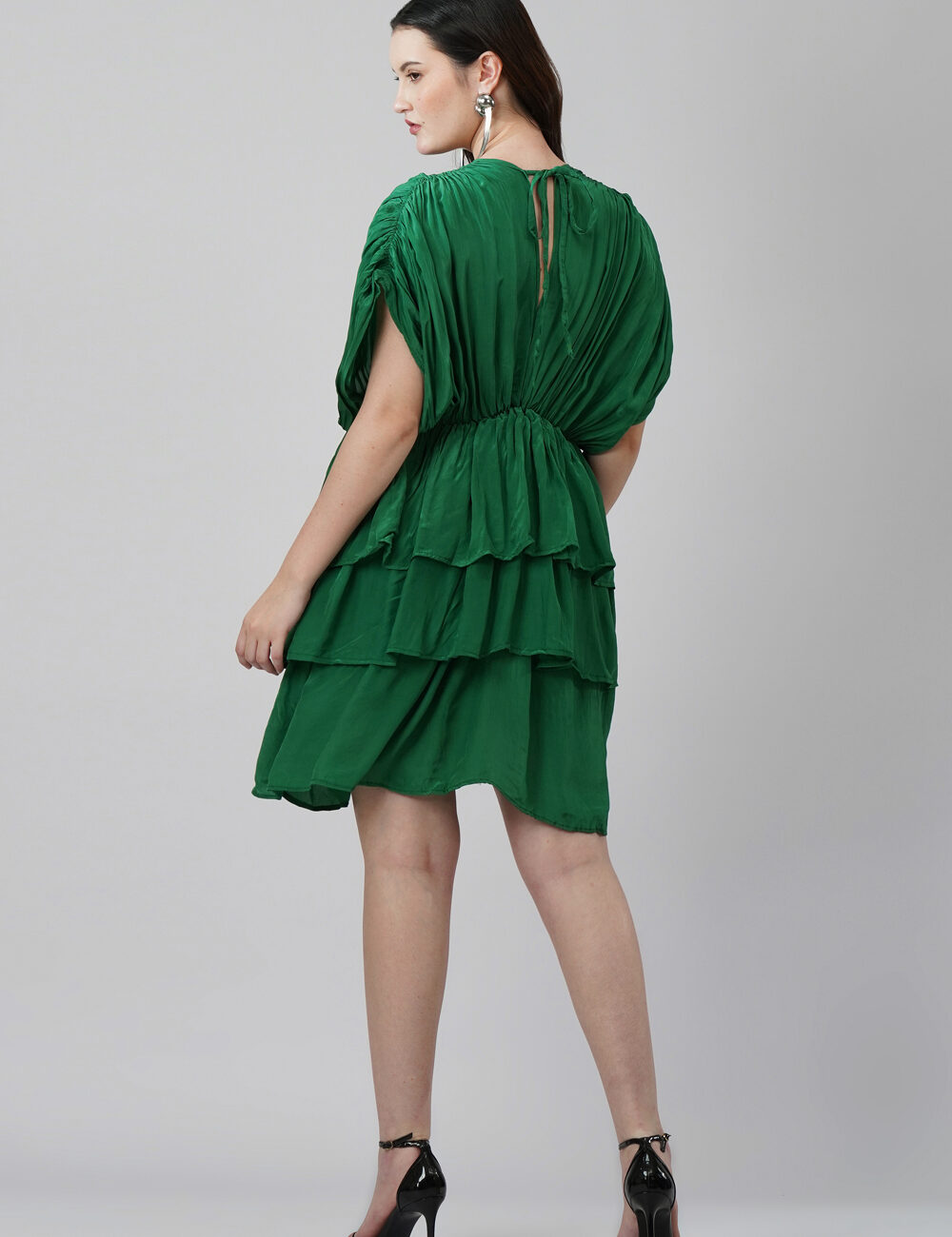Model wearing emerald green 3-layered V-neck party dress in natural crape