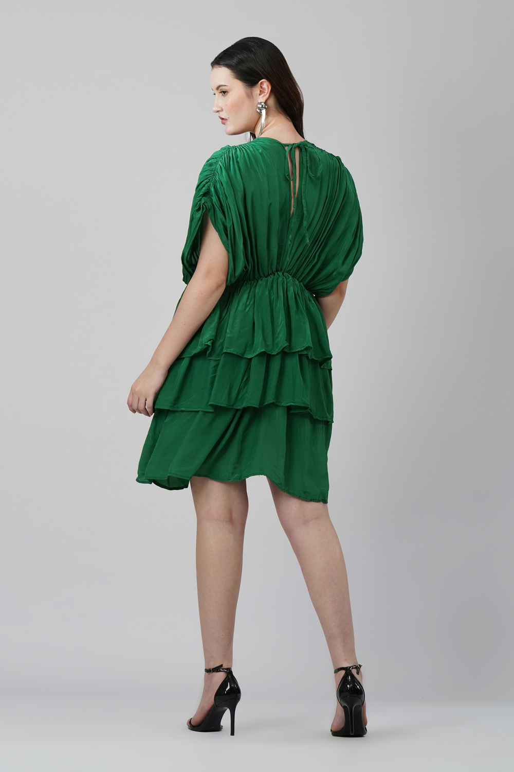 Model wearing emerald green 3-layered V-neck party dress in natural crape