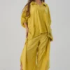 Model wearing mustard yellow cotton-linen co-ord set with embroidered pocket