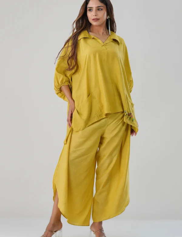Model wearing mustard yellow cotton-linen co-ord set with embroidered pocket