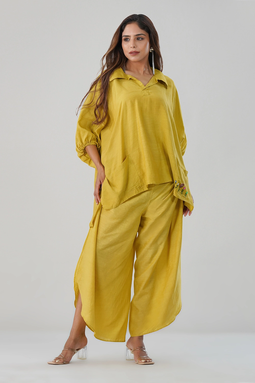 Model wearing mustard yellow cotton-linen co-ord set with embroidered pocket